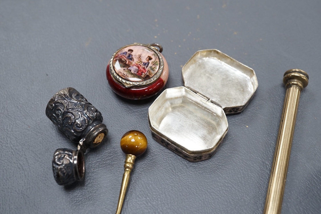 A 19th century Viennese gilt white metal and enamel circular vinaigrette, makers mark J.i.G, diameter 29mm, together with two late 19th century silver mounted senet bottles, a white metal and enamel pill box, a propellin